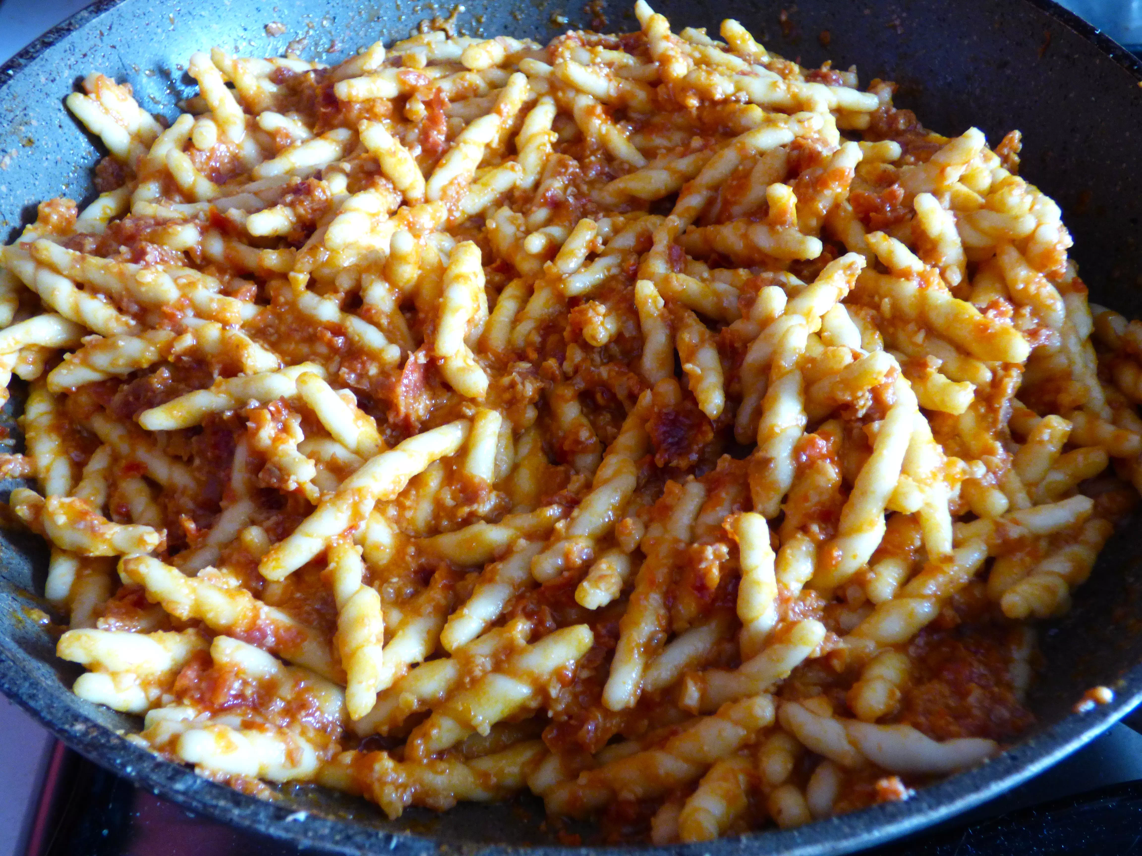 Foto pasta al pesto vegano di pomodori secchi e mandorle